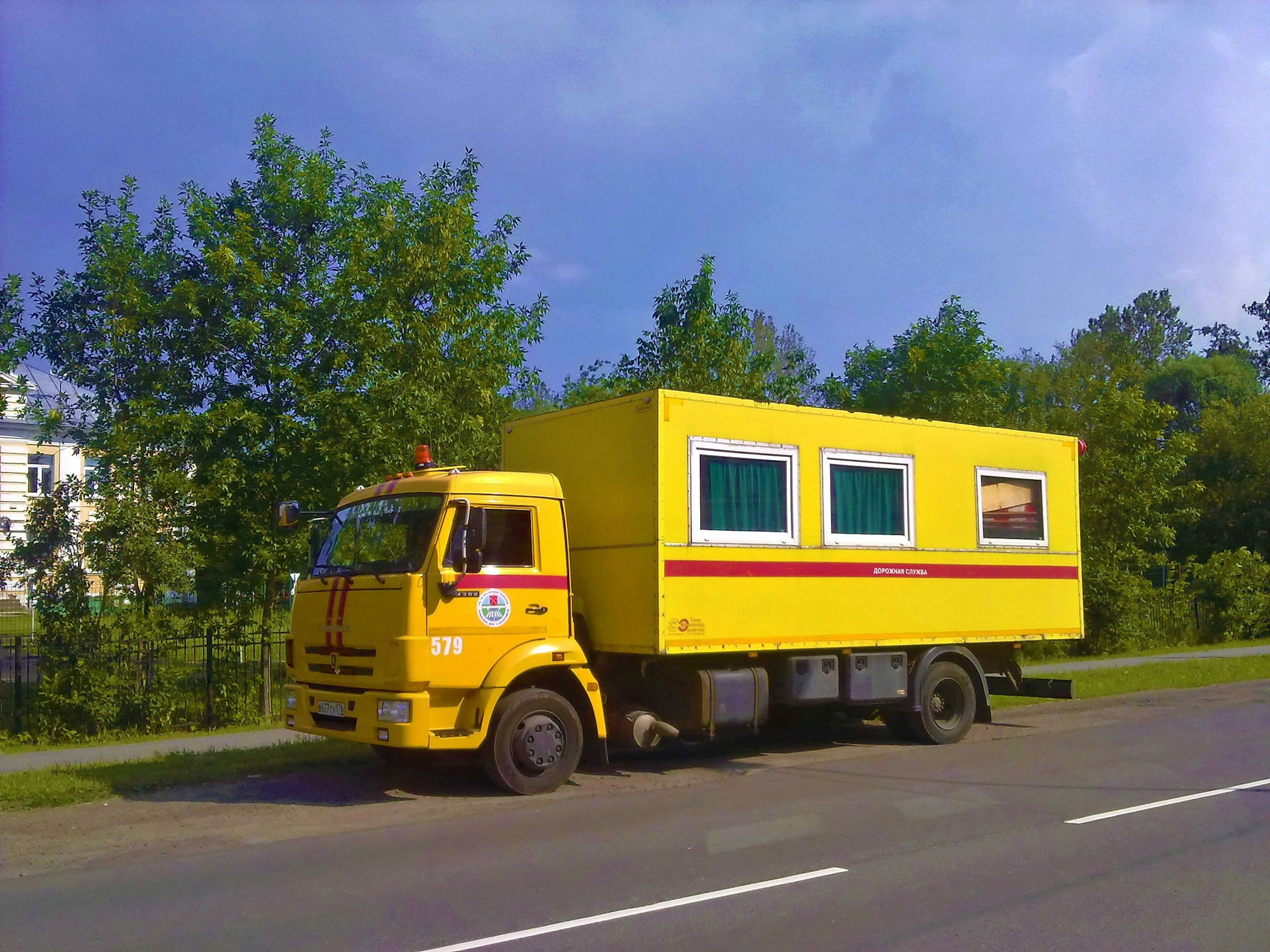 Yellow delivery truck parked by the roadside